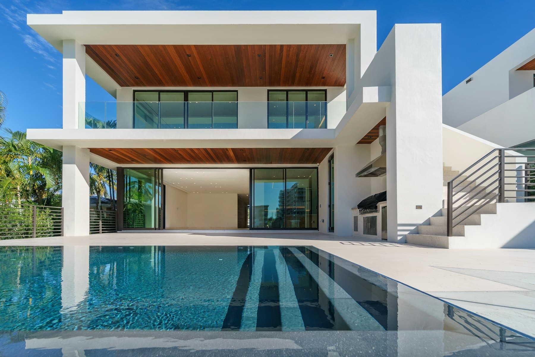 A contemporary house with a pool at dusk
